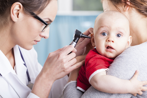 pediatrician looking babys ear