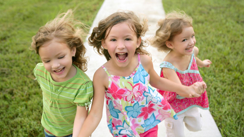 girls running on sidewalk