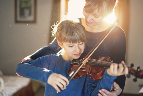Mother and daughter violin lesson