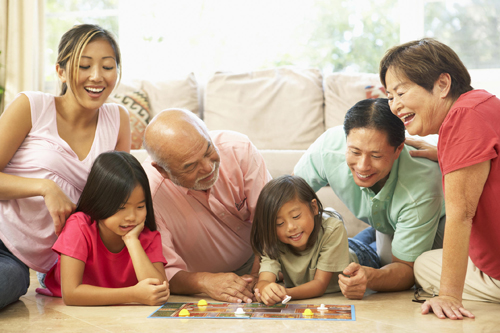 family playing board game together