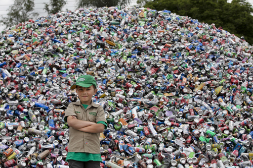 Ryan Hickman in front of a pile of recyclables
