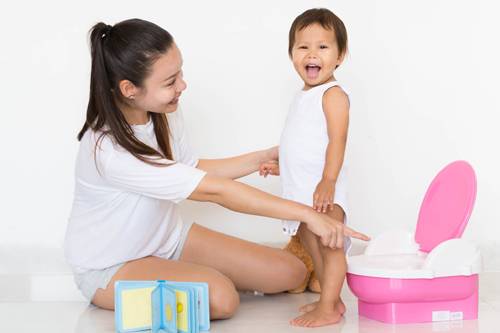 mother potty training little girl