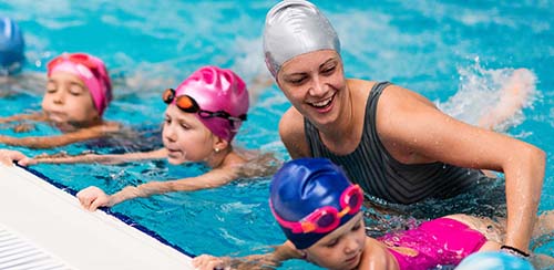 young kids taking swimming lessons