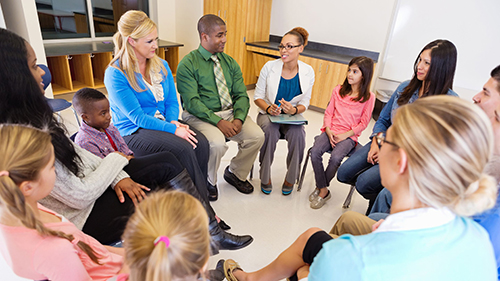 parents and students in a circle talking