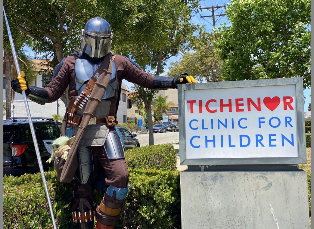 mandalorian stands next to hospital sign; Local heroes