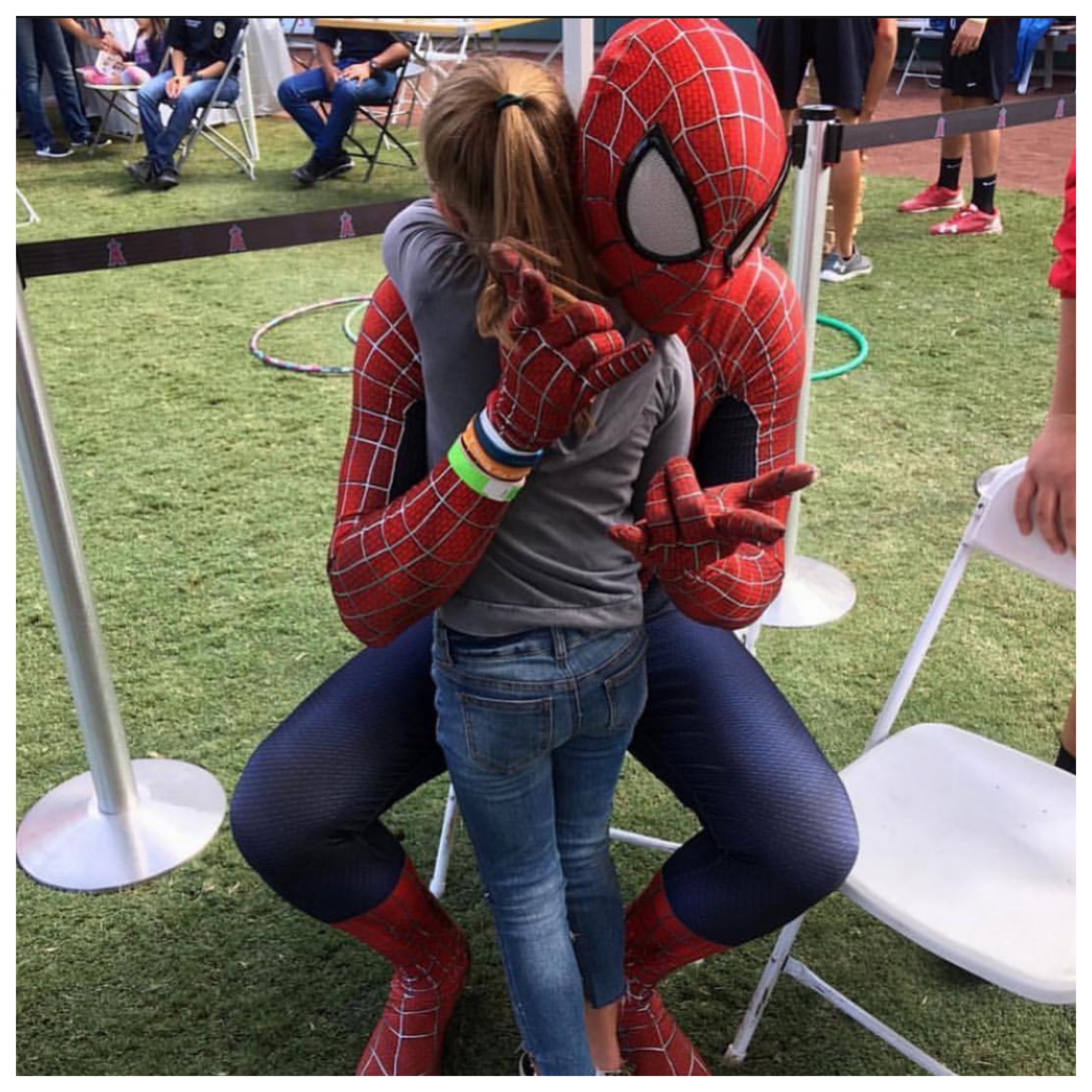 Spiderman hugging a child; Local Heros 