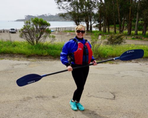 Ronda Tierney with kayak paddle at San Simeon Cove