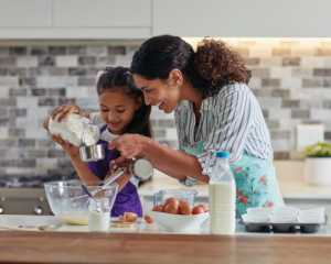 Mindful mother and daughter spending time with each other baking