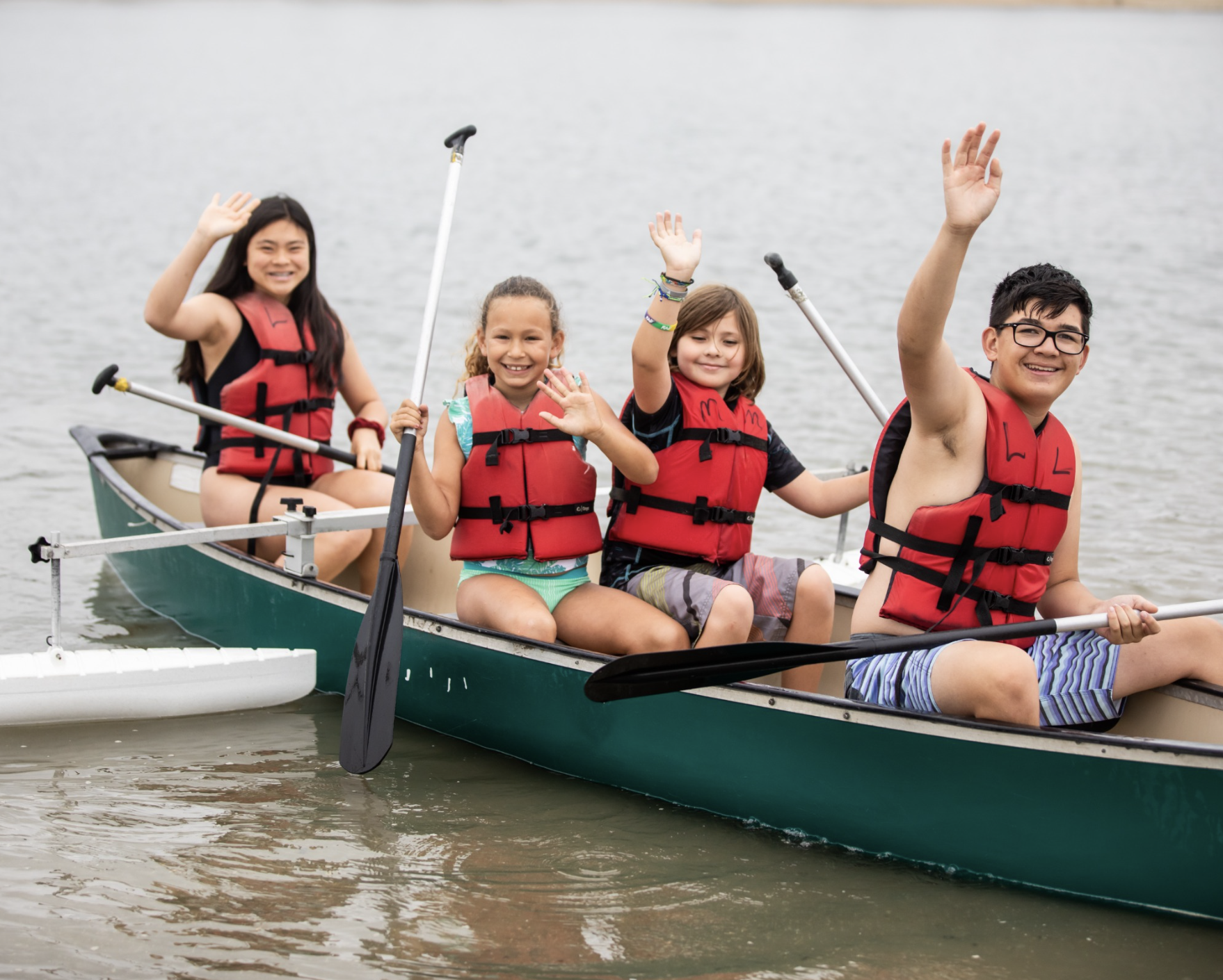 A group of kids in a kayak at Camp James Best Traditional Day Camp