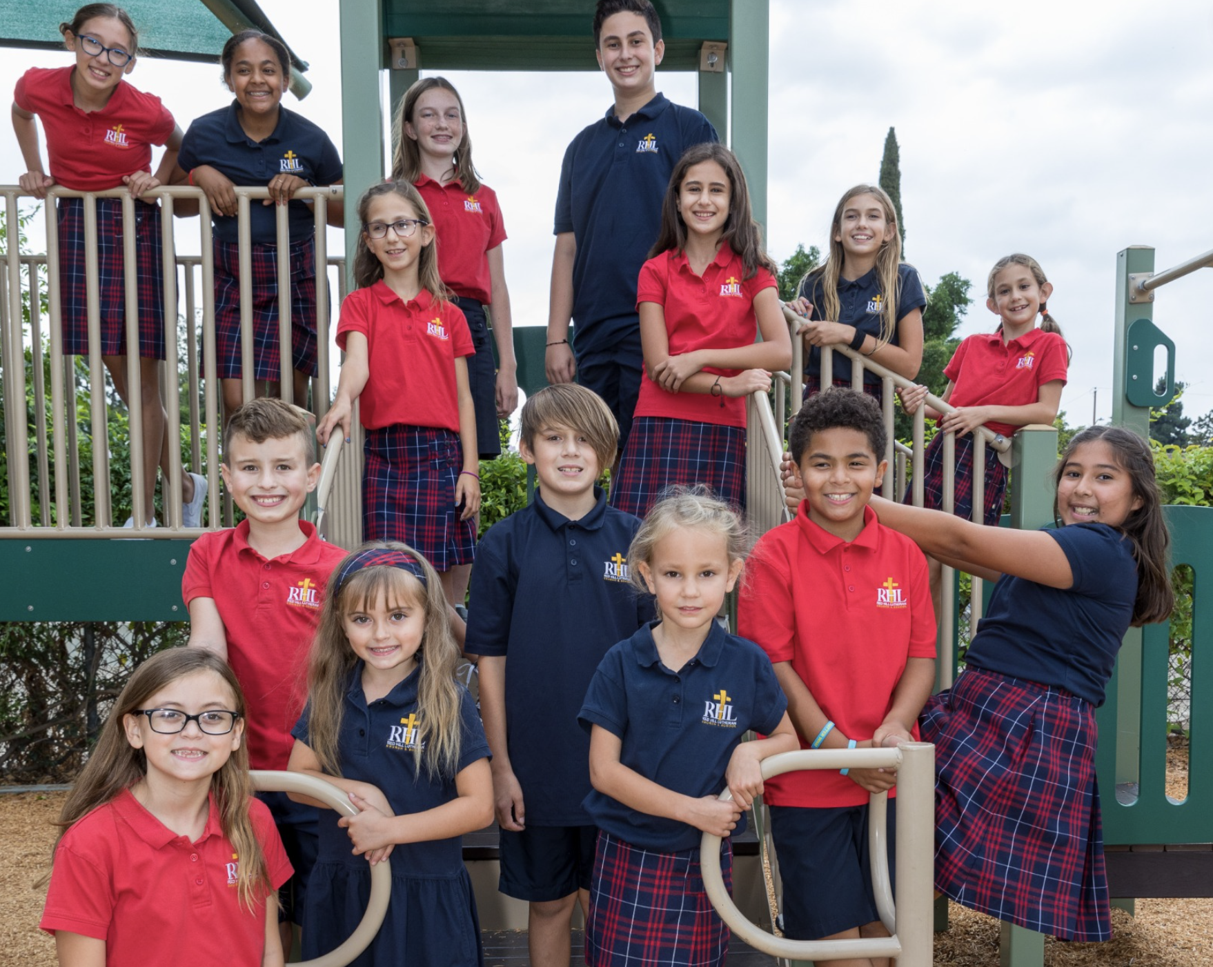Students in uniform posing on a playground for a picture at Red Hill Lutheran Best Faith-Based School