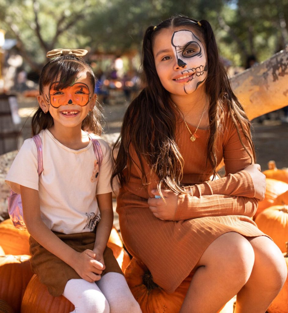 Two girls in face paint at the Irvine park railroad pumpkin patch