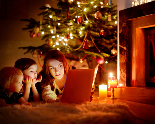 Mom reading a Christmas story to her little girls