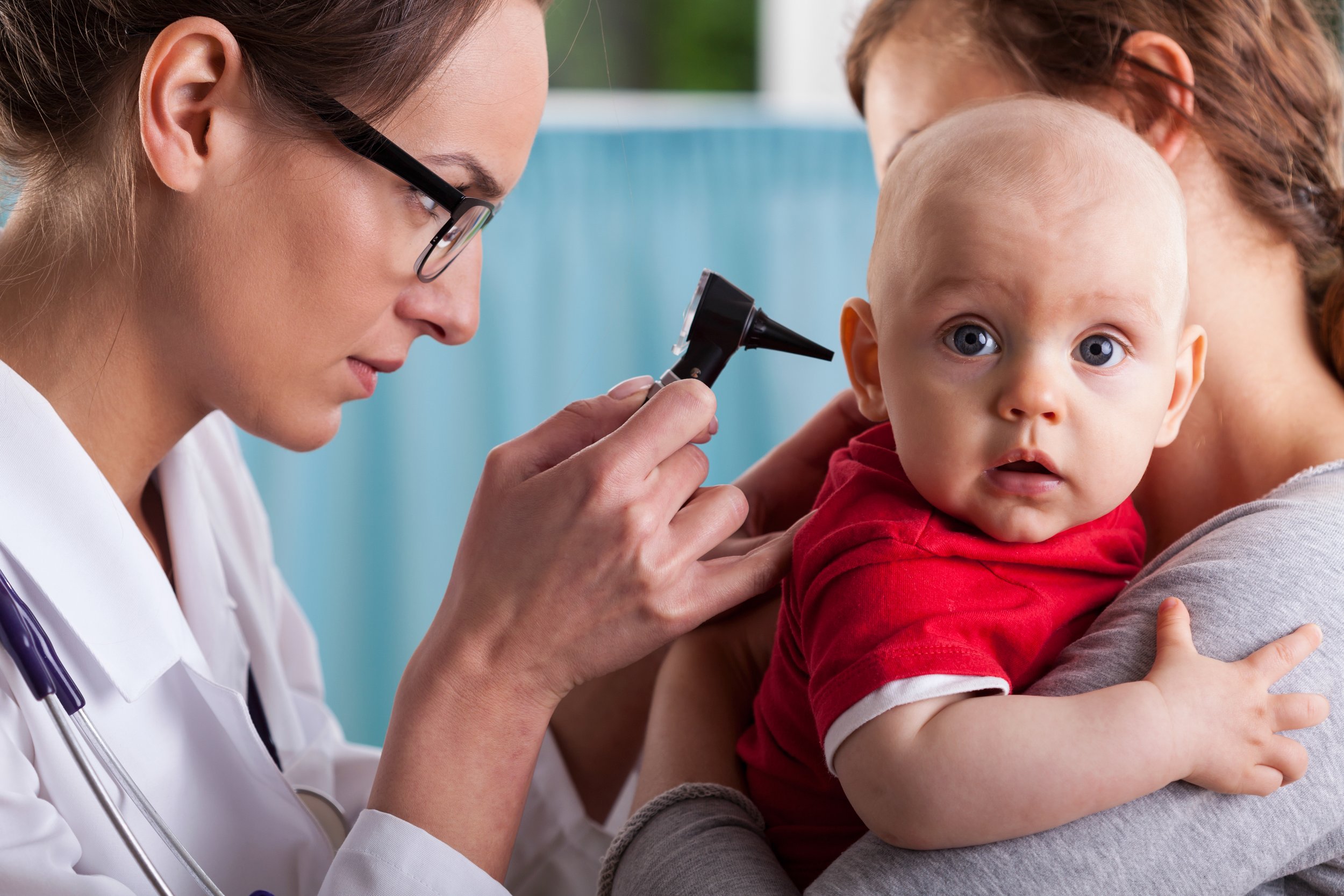 Child's otolaryngologist doing ear examination