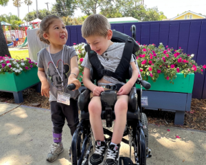 Little girl and boy in a wheelchair at Beyond Blindness summer camp